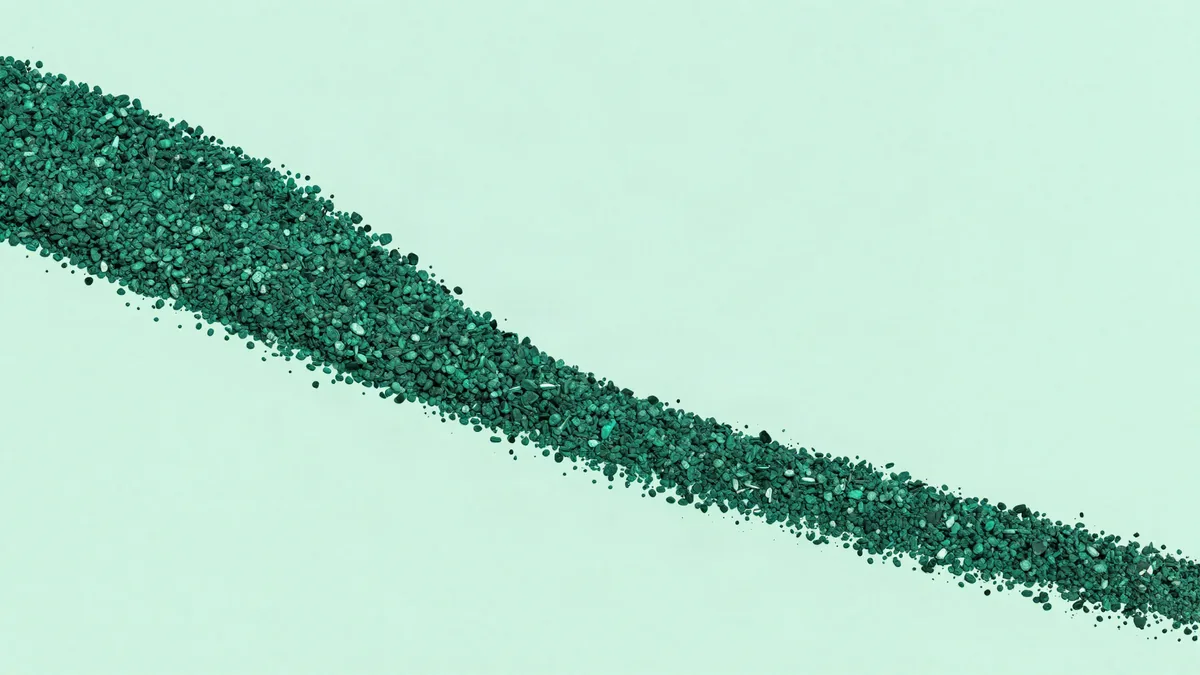 Flat illustration of a dense diagonal stream of small green particles flowing across a pale mint background, thinning out towards one end
